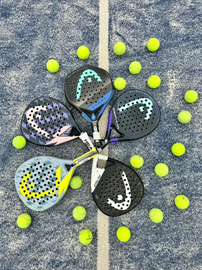 a pair of tennis rackets and balls on the ground